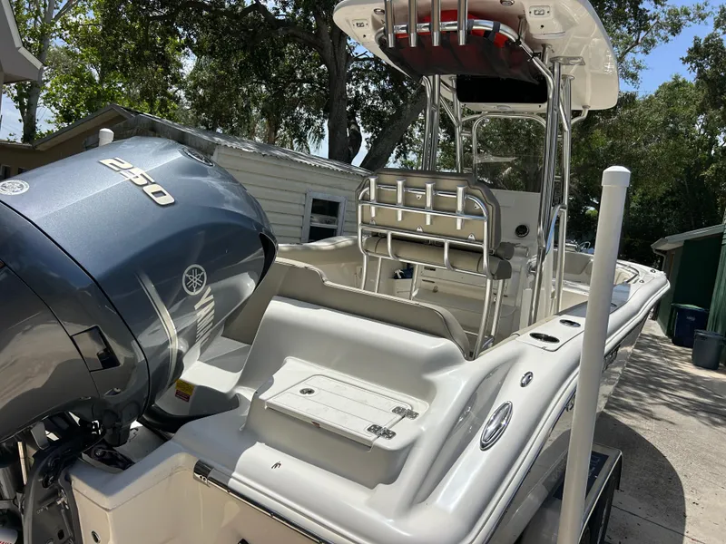 Slide: The Image of 2023 Key West 239 FS boat with Yamaha engine, parked outdoors. - 8