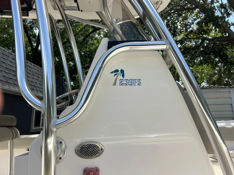 Slide: The Image of 2023 Key West 239 FS boat with sleek metal railings and logo detail. - 9