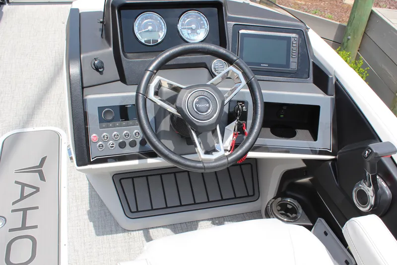 Slide: The Image of 2025 Tahoe Pontoon Cascade Quad Lounger dashboard with steering wheel and control panel. - 7