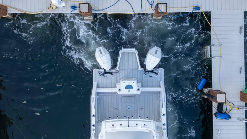 Slide: The Image of Aerial view of 2023 ArrowCat Flybridge Dual Helm boat docked at marina. - 21