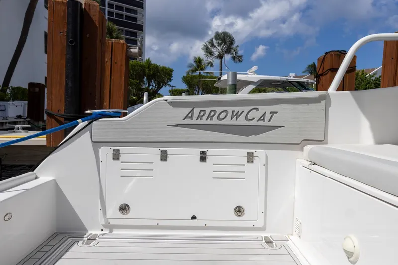 Slide: The Image of 2023 ArrowCat Flybridge Dual Helm boat docked, showcasing sleek design and branding. - 24
