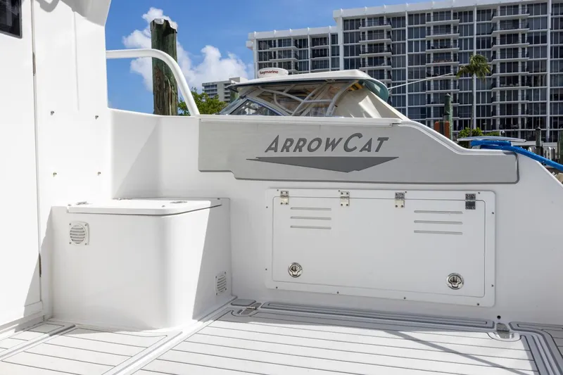 Slide: The Image of 2023 ArrowCat Flybridge Dual Helm boat docked near modern buildings. - 26