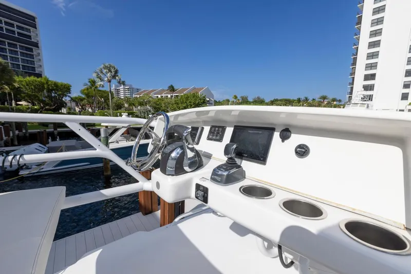 Slide: The Image of 2023 ArrowCat Flybridge Dual Helm with modern controls and scenic marina view. - 33