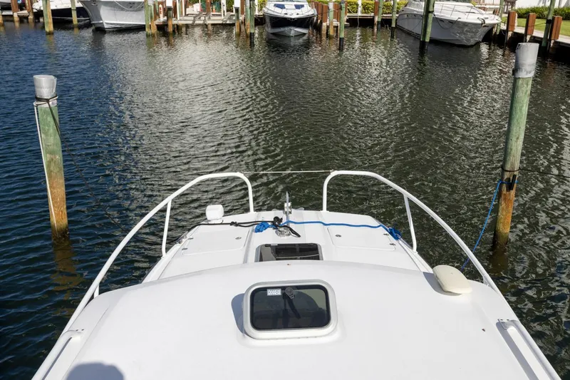 Slide: The Image of 2023 ArrowCat Flybridge Dual Helm boat docked at marina, view from helm. - 34