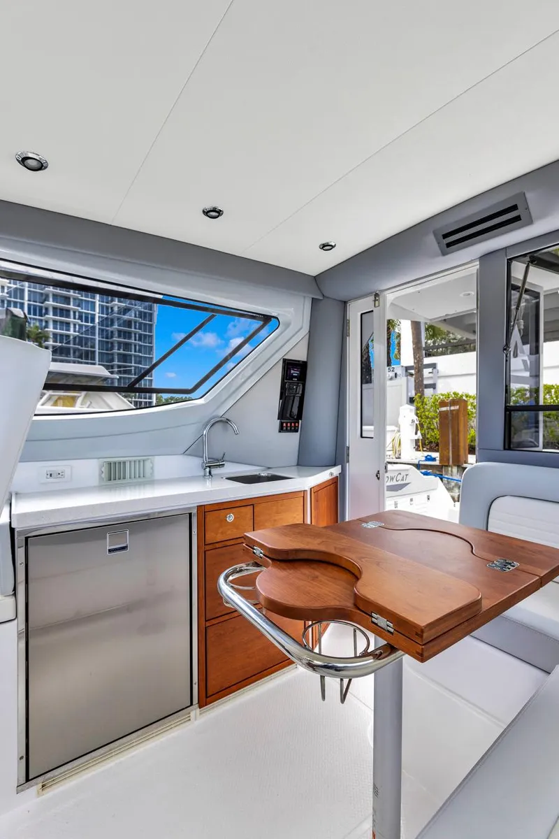 Slide: The Image of Interior of 2023 ArrowCat Flybridge Dual Helm yacht with modern kitchen and seating area. - 46
