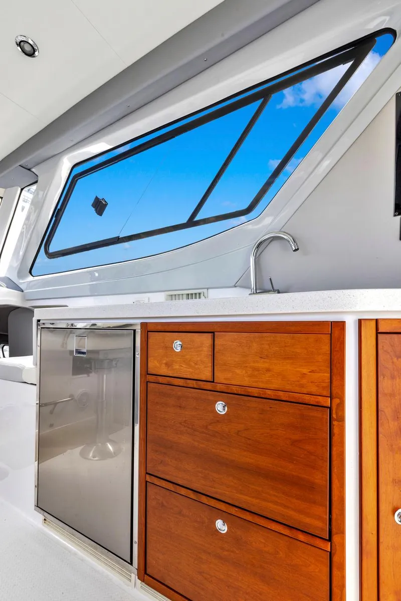 Slide: The Image of 2023 ArrowCat Flybridge Dual Helm yacht interior with wooden cabinetry and sleek window design. - 49