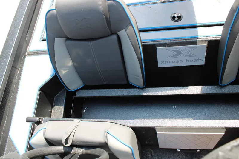 Slide: The Image of 2026 Xpress H18C Crappie boat interior with gray and blue seating. - 10