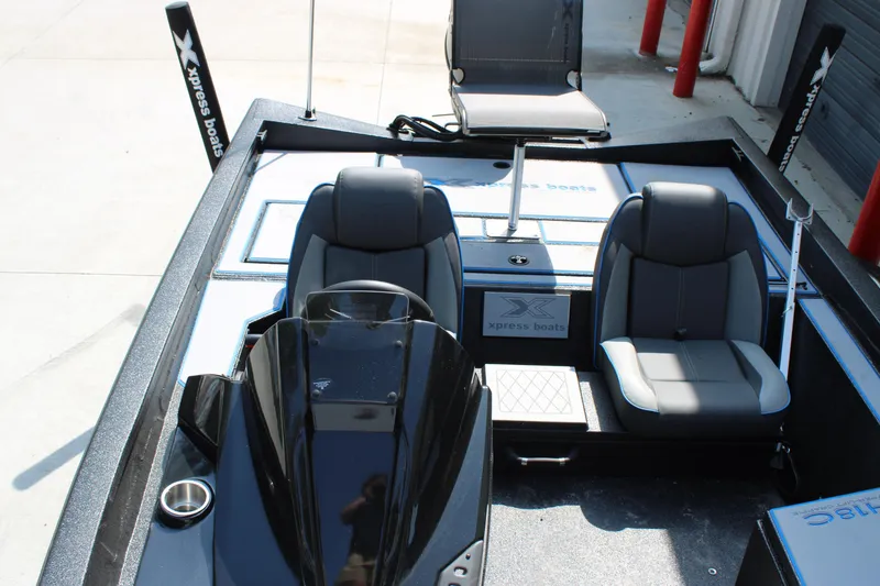 Slide: The Image of 2026 Xpress H18C Crappie boat interior with seating and console, ideal for fishing. - 6