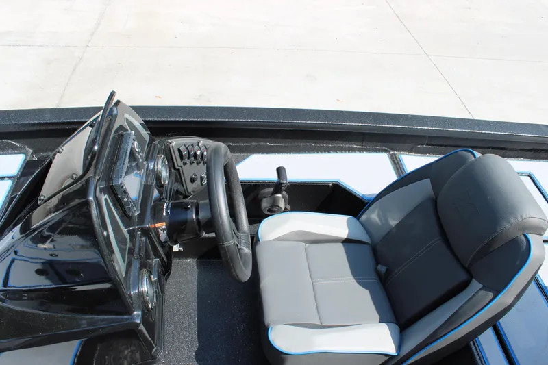Slide: The Image of 2026 Xpress H18C Crappie boat interior with steering wheel and seat. - 7