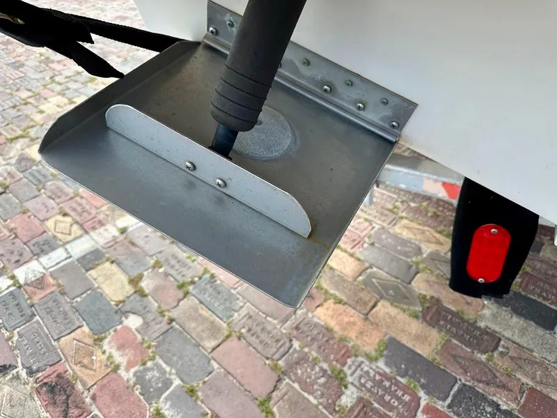 Slide: The Image of Trim tab of a 2004 Sea Ray SUNDECK 270 on a cobblestone surface. - 15