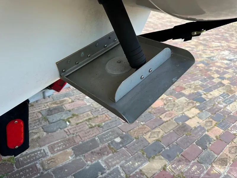 Slide: The Image of Trim tab on a 2004 Sea Ray SUNDECK 270 boat, displayed on a brick surface. - 16