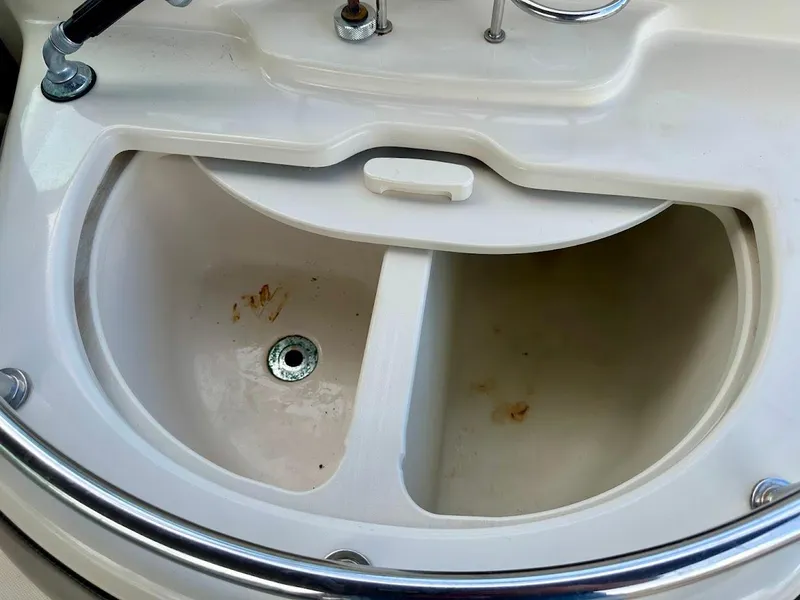 Slide: The Image of 2004 Sea Ray SUNDECK 270 boat sink with dual compartments and chrome railing. - 20