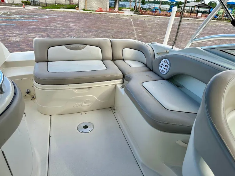 Slide: The Image of 2004 Sea Ray SUNDECK 270 interior with cushioned seating and speaker system. - 21