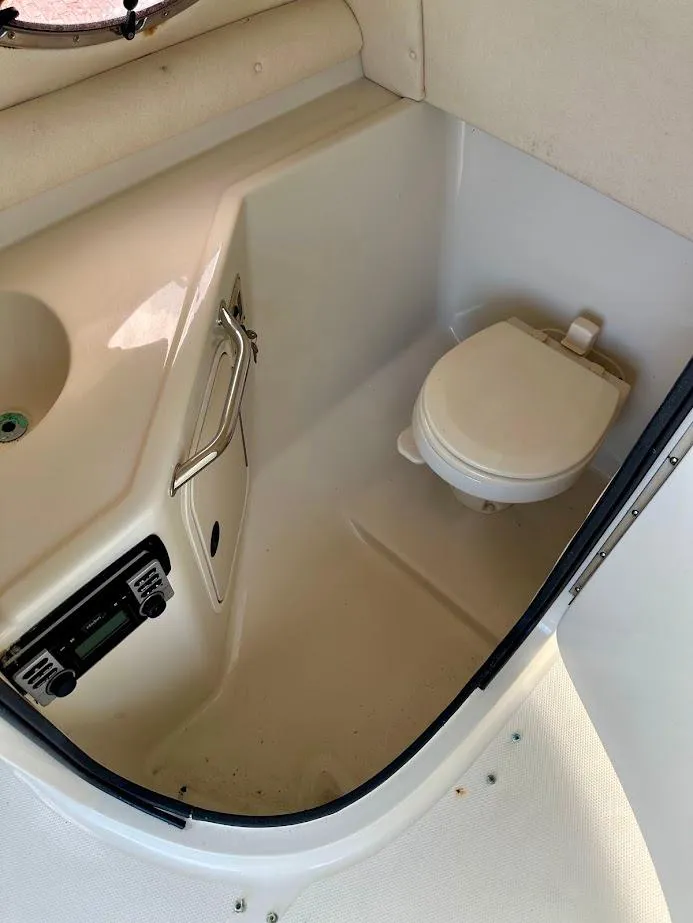 Slide: The Image of 2004 Sea Ray SUNDECK 270 boat bathroom with toilet and sink. - 29
