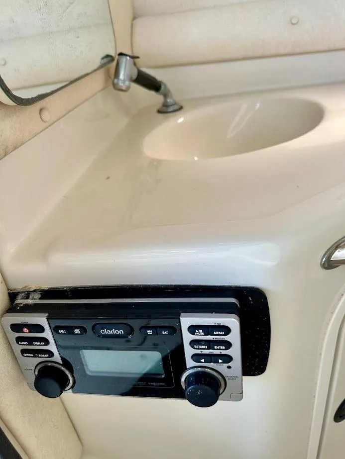 Slide: The Image of 2004 Sea Ray SUNDECK 270 interior with sink and control panel. - 30