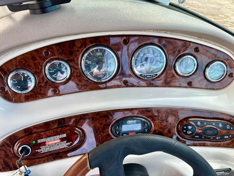 Slide: The Image of Dashboard of 2004 Sea Ray SUNDECK 270 boat with wood paneling and gauges. - 34