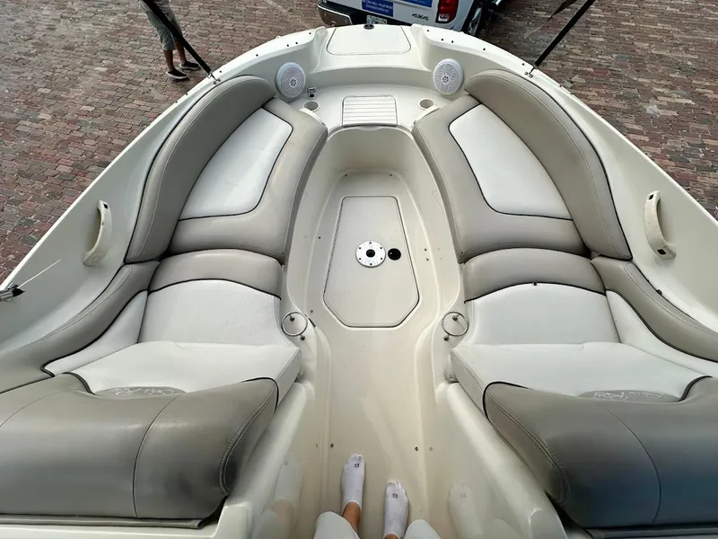Slide: The Image of 2004 Sea Ray SUNDECK 270 boat interior with cushioned seating and speakers. - 37