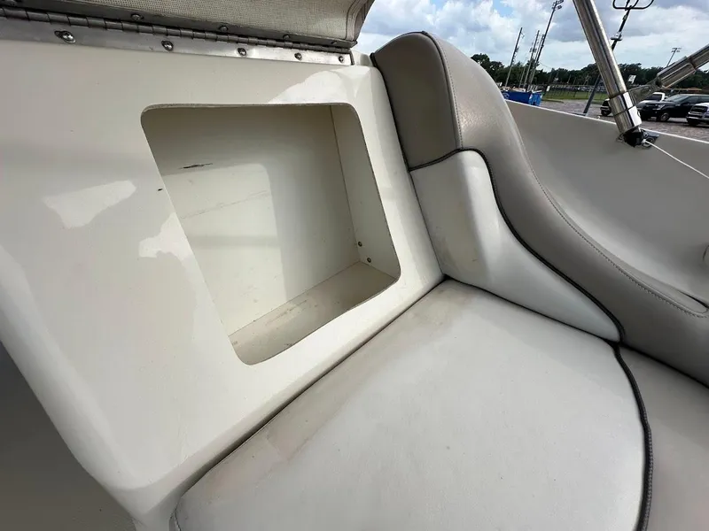 Slide: The Image of 2004 Sea Ray SUNDECK 270 interior seating with storage compartment. - 39