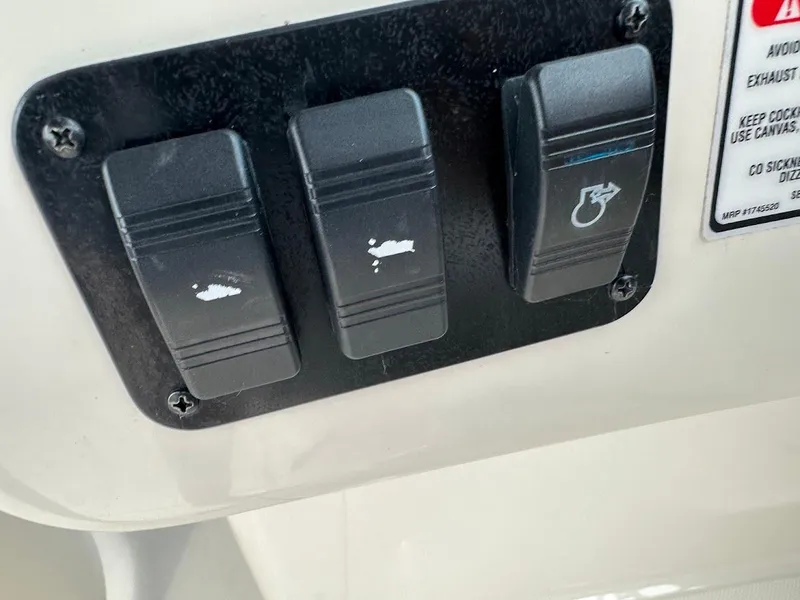 Slide: The Image of Control panel switches on a 2004 Sea Ray SUNDECK 270 boat. - 43