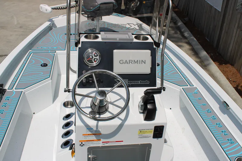 Slide: The Image of 2025 Xpress H20B boat dashboard with Garmin navigation system and steering wheel. - 10