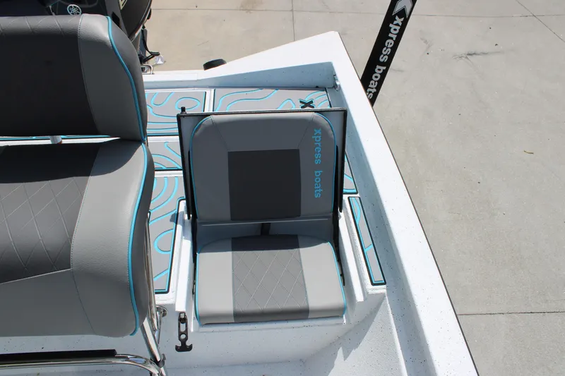 Slide: The Image of 2025 Xpress H20B boat seat with gray upholstery and blue accents. - 12
