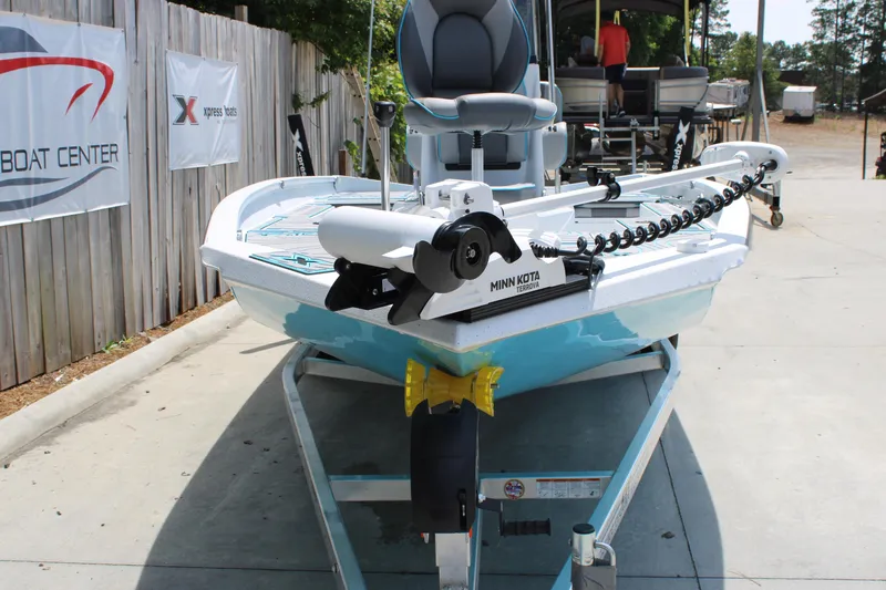 Slide: The Image of 2025 Xpress H20B boat with Minn Kota motor on trailer at dealership. - 2
