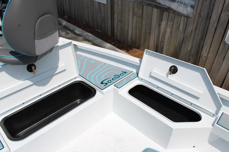 Slide: The Image of 2025 Xpress H20B boat storage compartments with SeaDek lining, open for viewing. - 5
