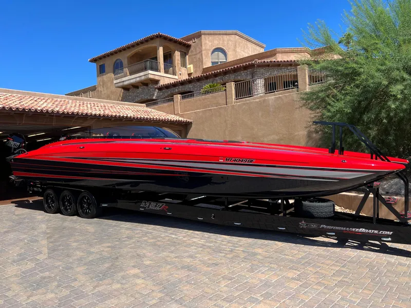 The Image of 2023 Daves Custom Boats M37R, red and black, parked on a trailer in a driveway. - 0
