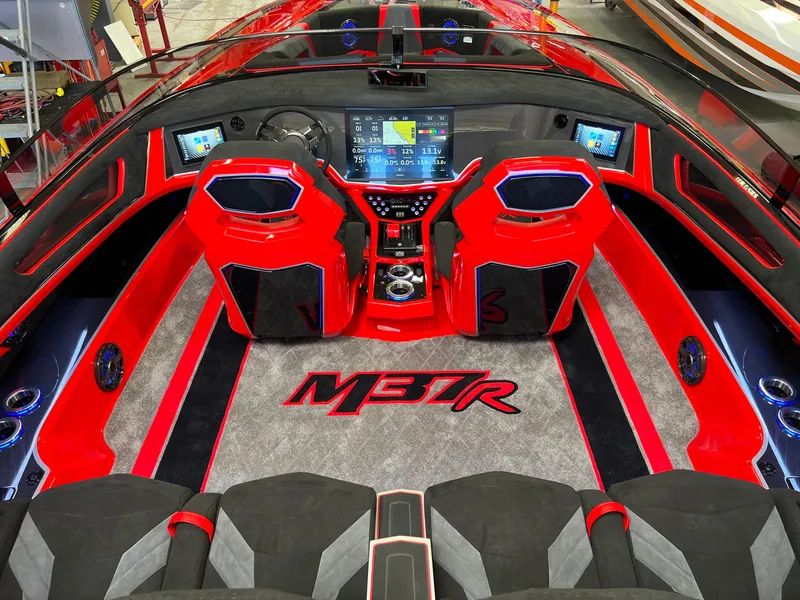 Slide: The Image of 2023 Daves Custom Boats M37R interior with red accents and advanced dashboard technology. - 18