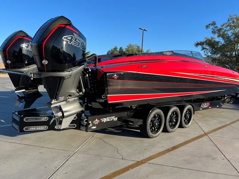 Slide: The Image of 2023 Daves Custom Boats M37R, red and black, with twin 450R engines on a trailer. - 2