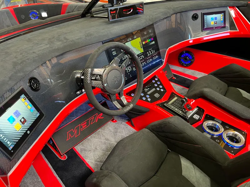 Slide: The Image of 2023 Daves Custom Boats M37R interior with high-tech dashboard and vibrant red accents. - 22