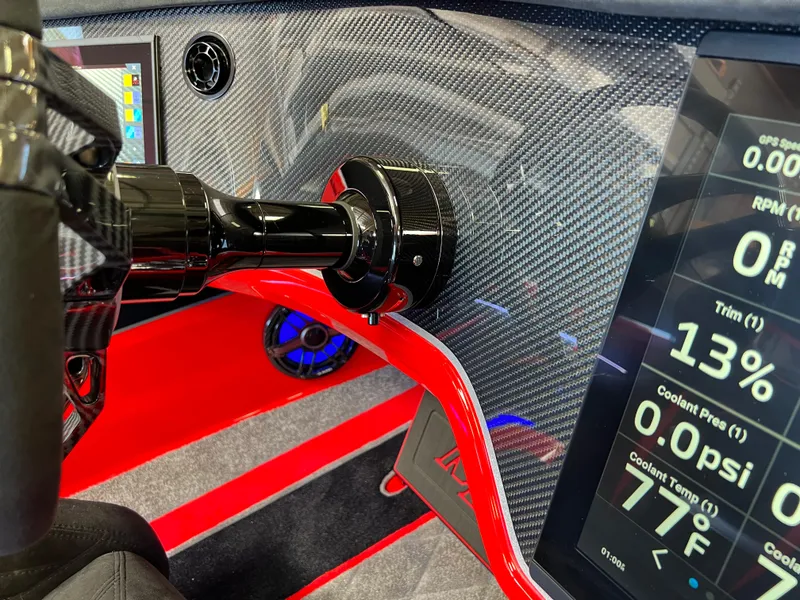Slide: The Image of 2023 Daves Custom Boats M37R dashboard with carbon fiber finish and digital display. - 23