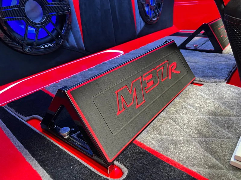 Slide: The Image of 2023 Daves Custom Boats M37R interior with red and black accents, featuring premium audio system. - 29