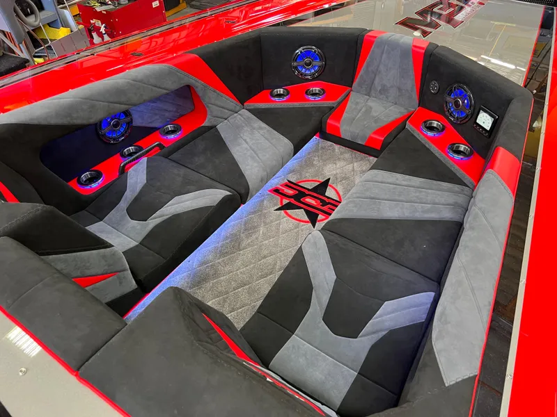 Slide: The Image of 2023 Daves Custom Boats M37R interior with red and gray seating and audio system. - 32