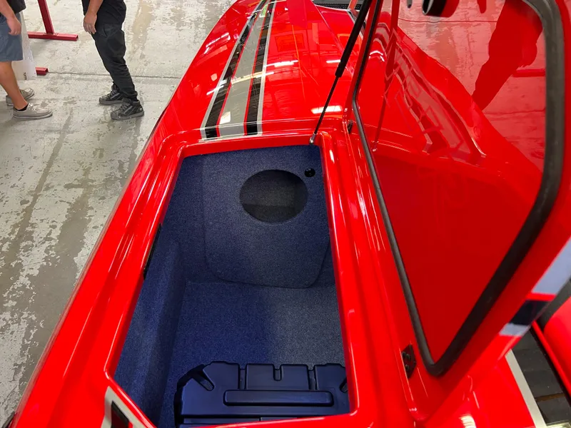 Slide: The Image of 2023 Daves Custom Boats M37R, red exterior, open storage compartment, sleek design. - 36