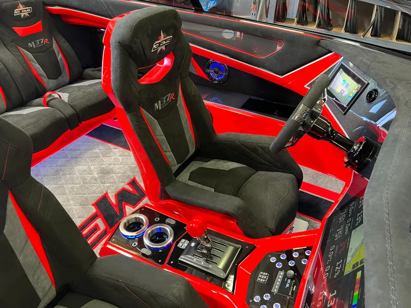 Slide: The Image of 2023 Daves Custom Boats M37R interior with red and black seating, modern controls, and touchscreen display. - 7