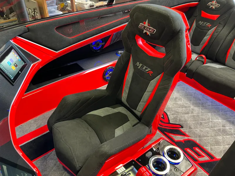 Slide: The Image of 2023 Daves Custom Boats M37R interior with red and black seats, modern design, and control panel. - 8