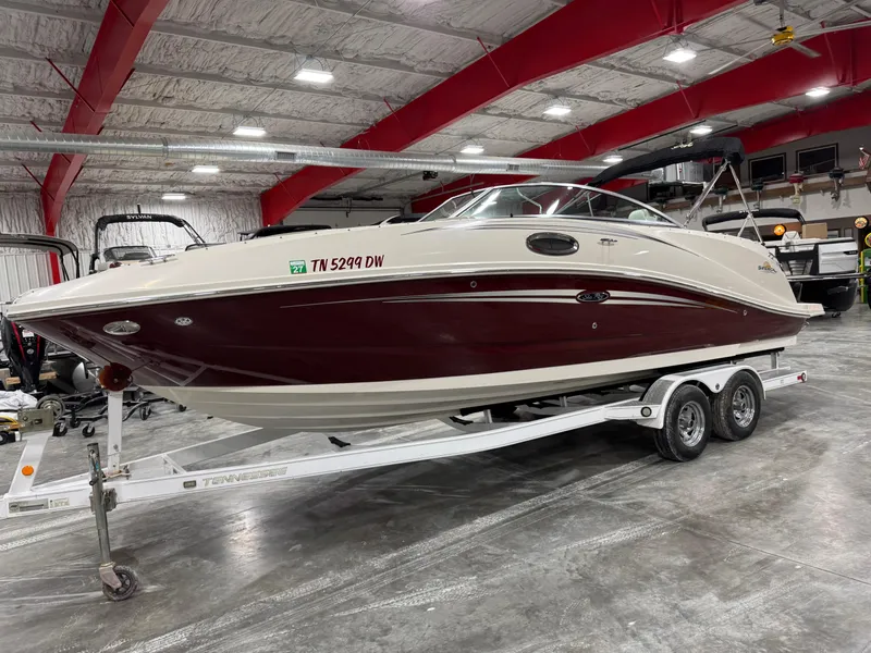 The Image of 2006 Sea Ray 260 Sundeck boat on trailer in indoor storage facility. - 1