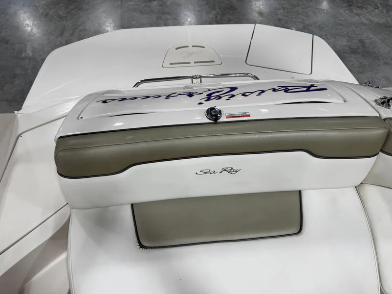 Slide: The Image of 2006 Sea Ray 260 Sundeck boat interior with white and beige seating. - 11