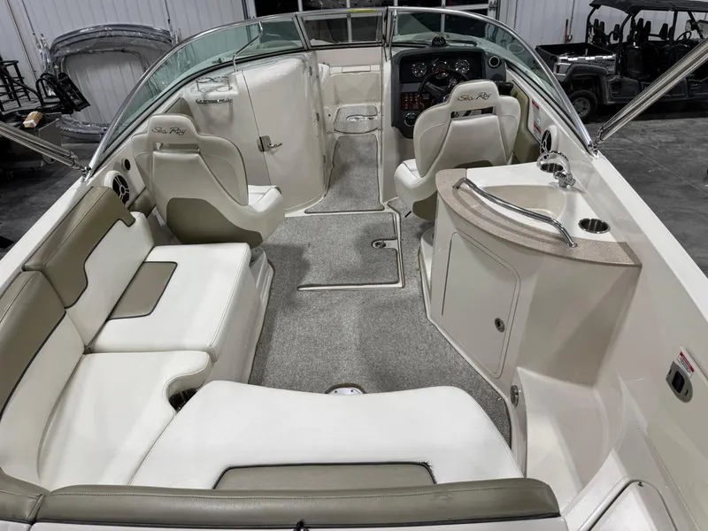 Slide: The Image of 2006 Sea Ray 260 Sundeck interior with seating, helm, and sink. - 6