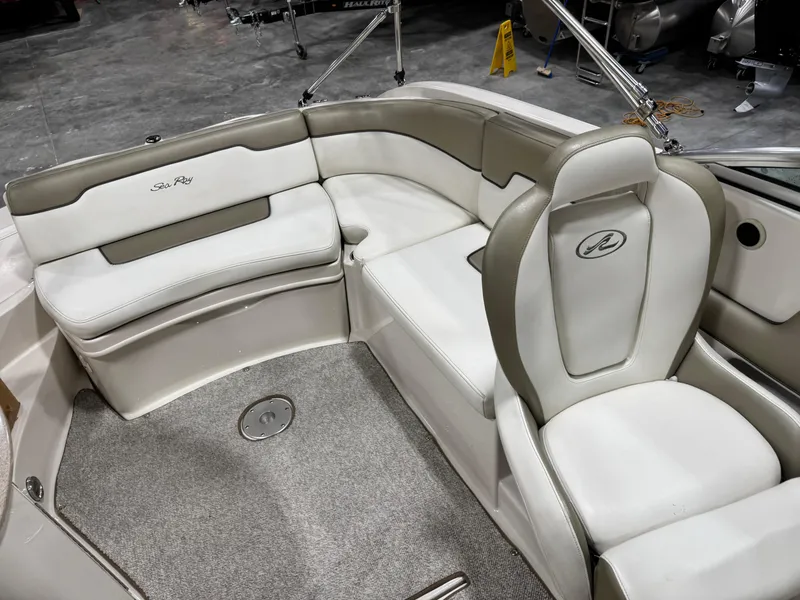 Slide: The Image of 2006 Sea Ray 260 Sundeck interior with white and gray seating, showcasing luxury and comfort. - 7