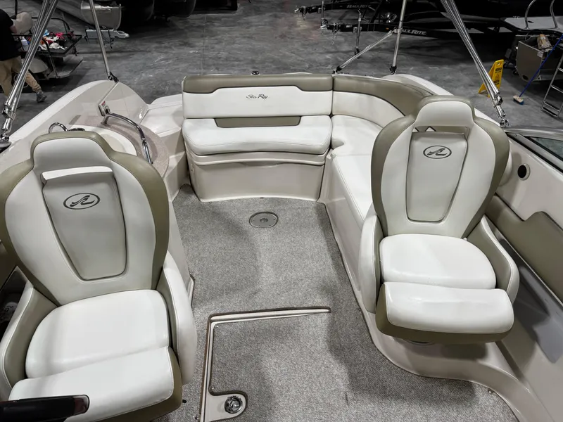 Slide: The Image of 2006 Sea Ray 260 Sundeck interior with white seating and carpeted floor. - 8