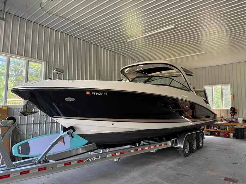The Image of 2015 Sea Ray 350 SLX boat on trailer in a garage. - 0