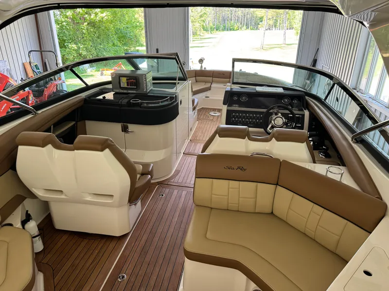 Slide: The Image of 2015 Sea Ray 350 SLX boat interior with luxurious seating and modern dashboard. - 11