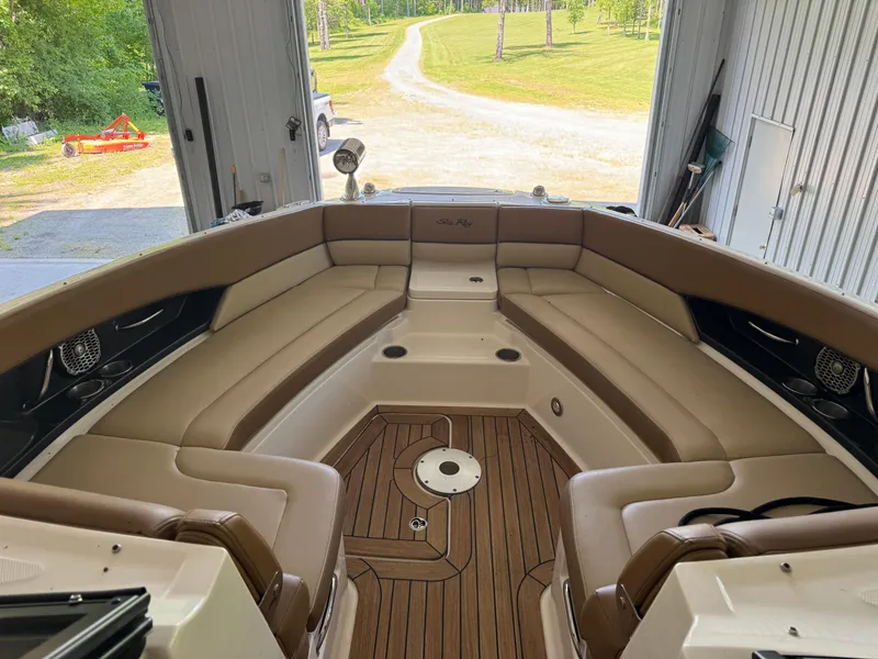 Slide: The Image of 2015 Sea Ray 350 SLX boat interior with tan seating and wood flooring in a garage. - 16