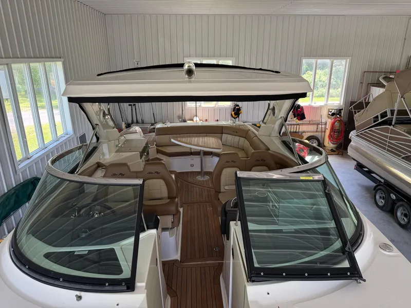 Slide: The Image of 2015 Sea Ray 350 SLX boat in a garage, featuring spacious seating and modern design. - 19