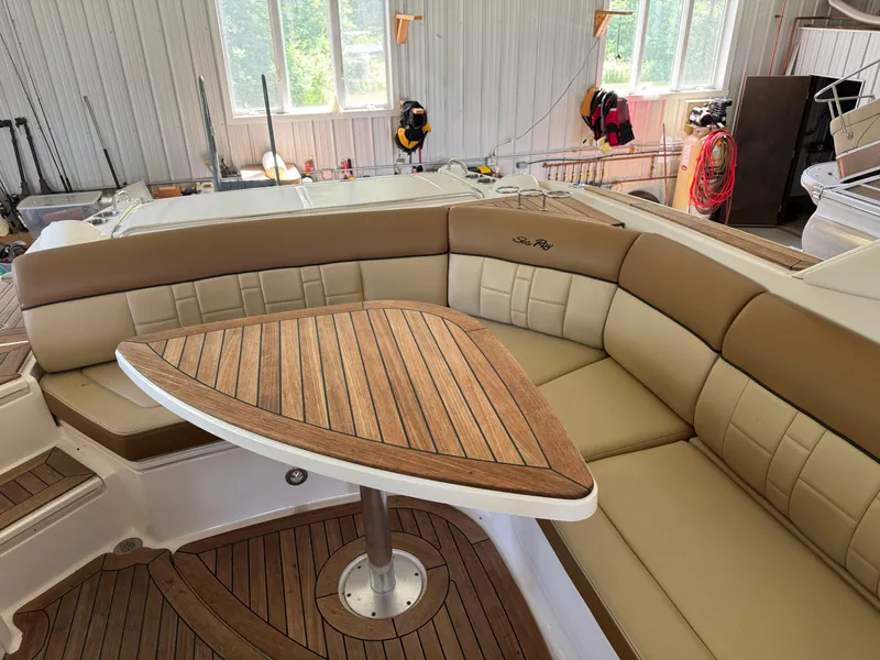 Slide: The Image of Luxurious 2015 Sea Ray 350 SLX boat interior with tan leather seating and wooden table. - 23