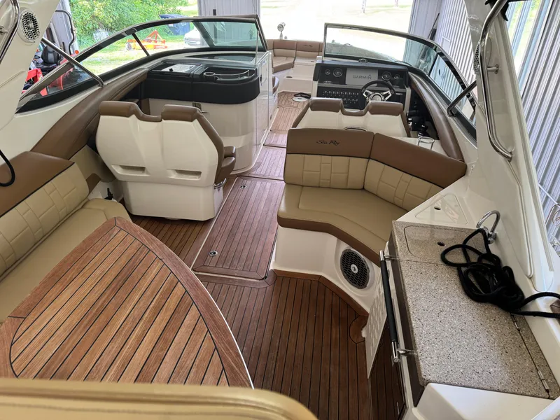 Slide: The Image of 2015 Sea Ray 350 SLX boat interior with luxurious seating and wood finish. - 3