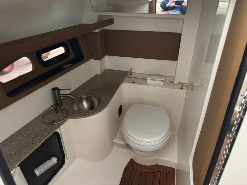 Slide: The Image of 2015 Sea Ray 350 SLX boat bathroom with sink, toilet, and modern design. - 5