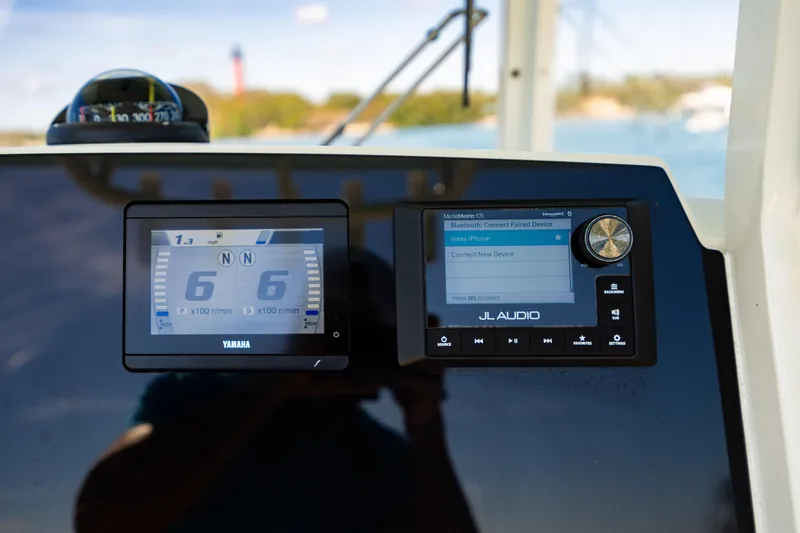 Slide: The Image of 2022 Cobia 240 CC dashboard with Yamaha display and JL Audio system. - 16